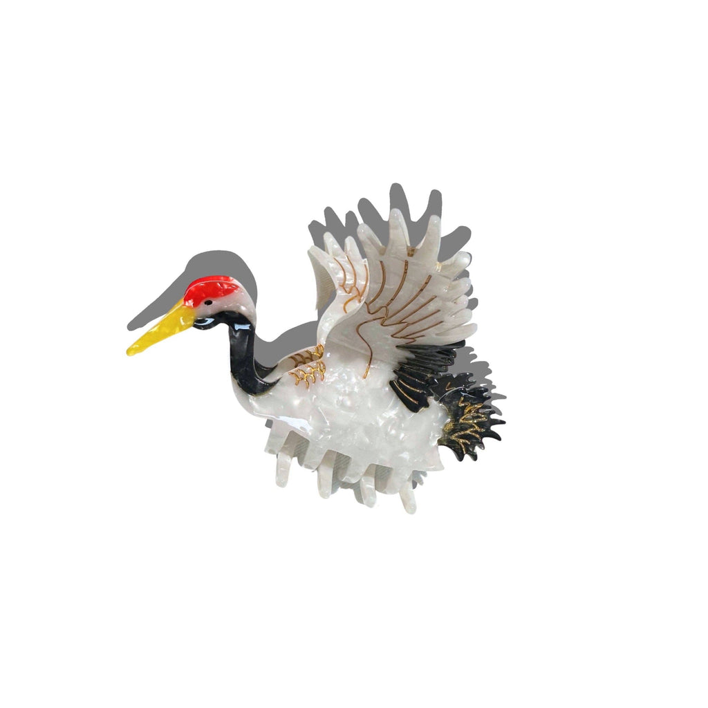 Decorative figurine of a bird with a red head on a white background