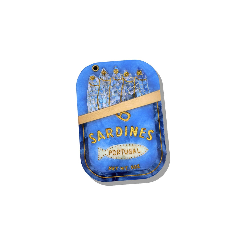 Blue sardine can-shaped pouch with gold accents on a white background