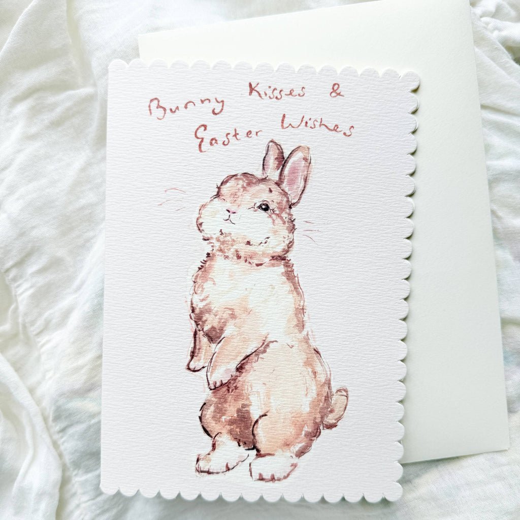 Greeting card with a bunny illustration and 'Bunny Kisses & Easter Wishes' text on a white textured background.