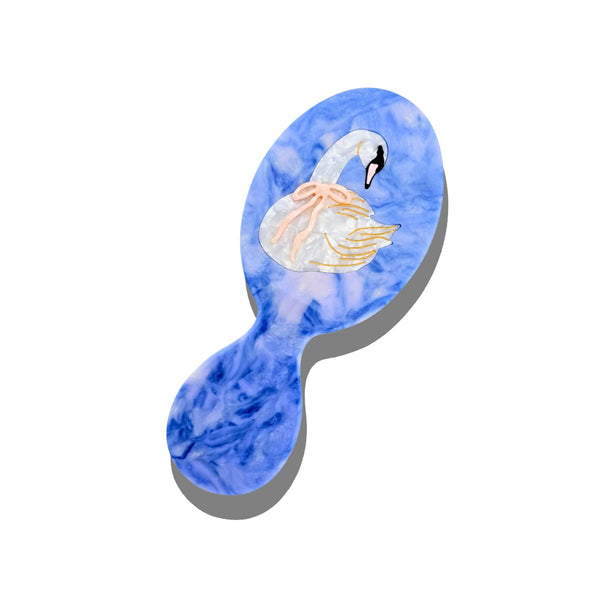 Hairbrush with a blue watercolor design of a swan on a white background