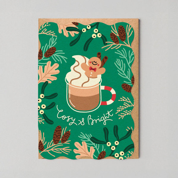 Holiday-themed card with hot chocolate illustration and festive elements on a green background