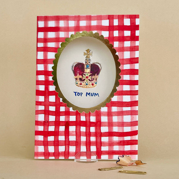 Card with a red and white checkered design featuring a crown and 'Top Mum' text on a beige background.