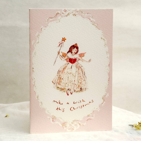 Greeting card with an angel illustration and text on a pink background