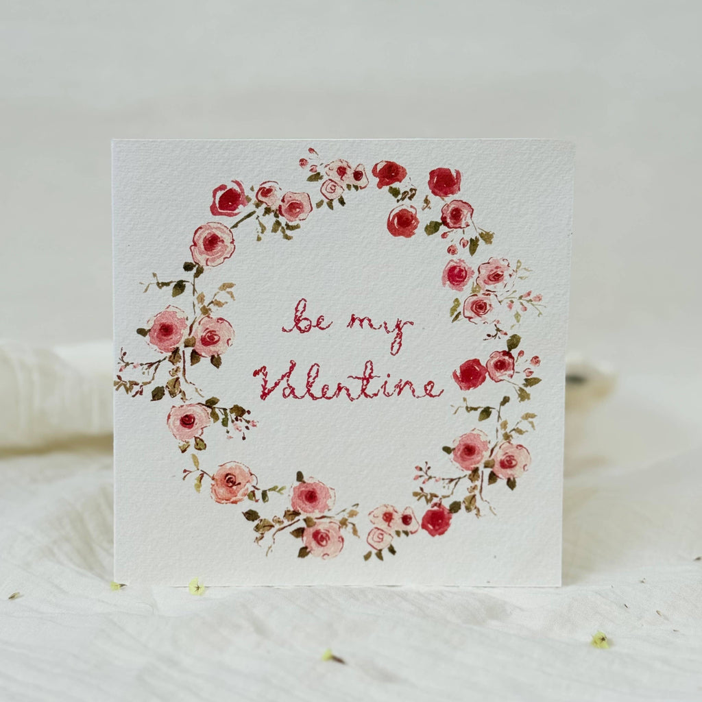 Valentine's Day card with floral design and 'Be my Valentine' text on a white background.