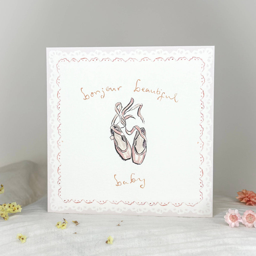 Card with ballet shoes illustration and text on a gray background