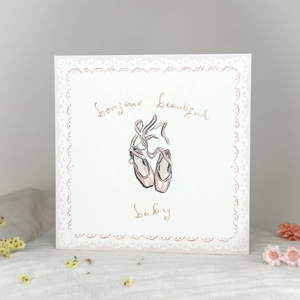 Card with ballet shoes illustration and text on a gray background
