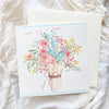 Greeting card with floral design on a white textured surface