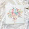 Greeting card with floral design and text on a white fabric background