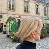 Person with a decorative hair clip in an urban setting