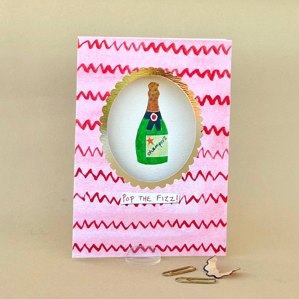Card with champagne bottle illustration on a pink and red striped background