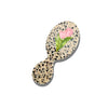 Small round brush with floral design on a white background