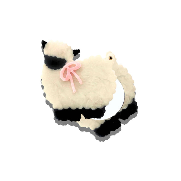 Plush toy resembling a cat with sunglasses and a bow on a white background