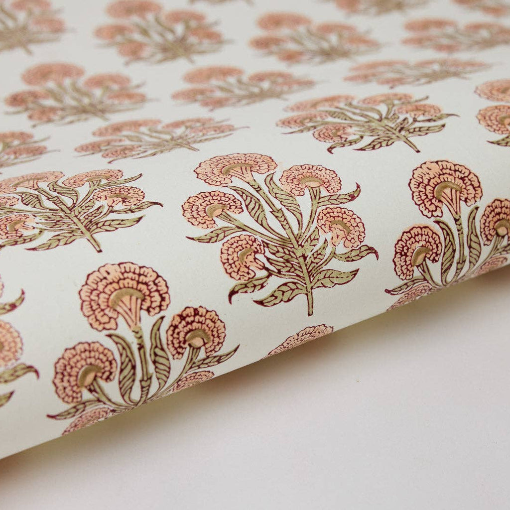 Floral patterned fabric with pink and green flowers on a white background