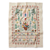 Embroidered fabric with garden scene and text on a white background