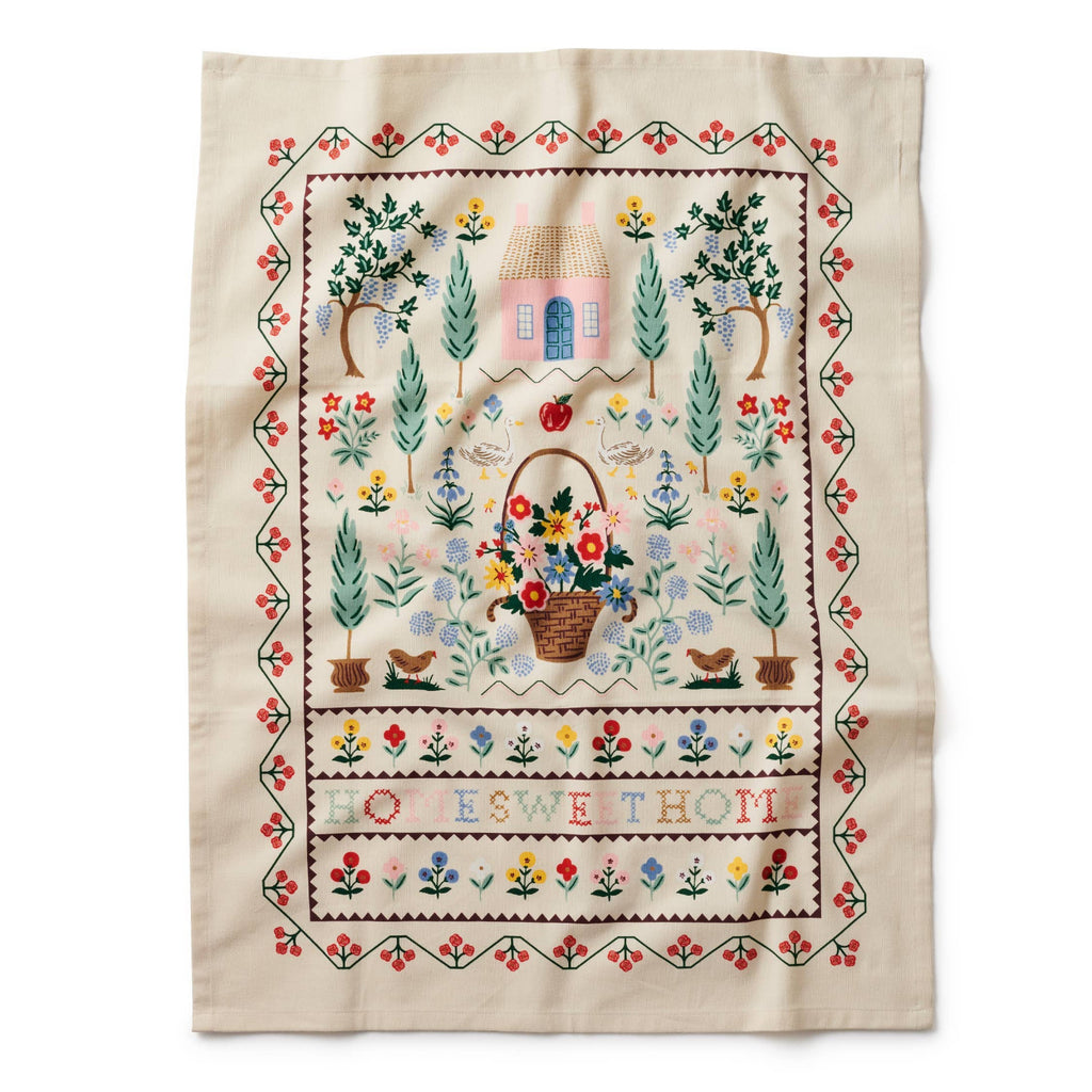 Embroidered fabric with garden scene and text on a white background