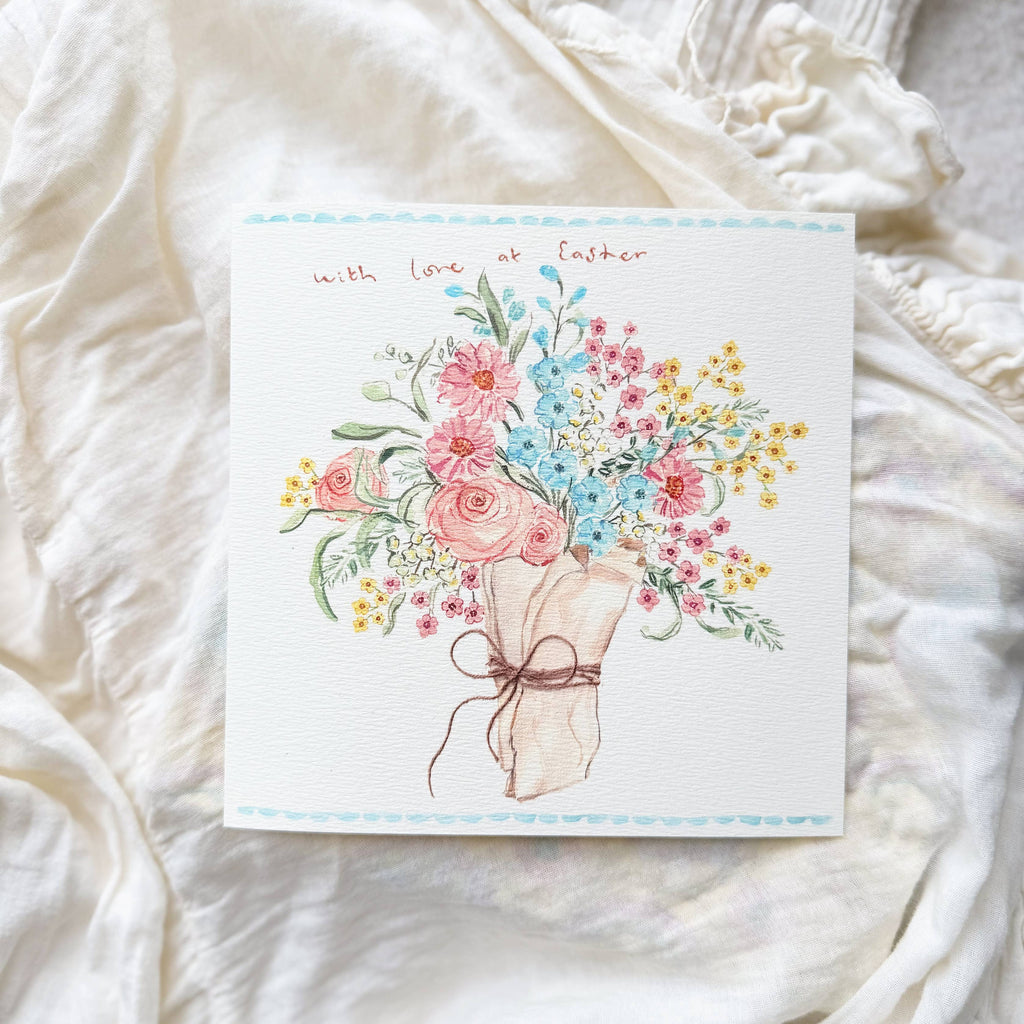 Card with floral design on a soft white fabric background