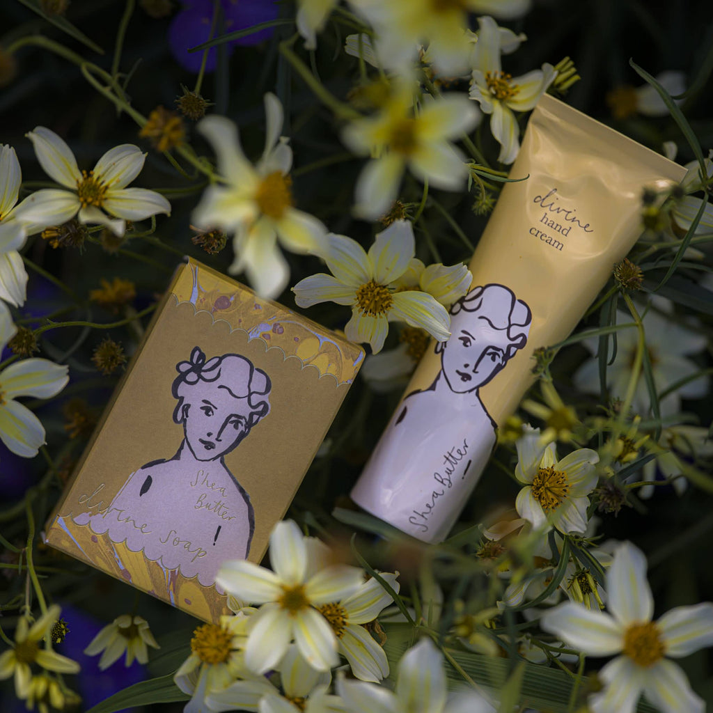 Hand cream and soap bars with floral design on a bed of flowers