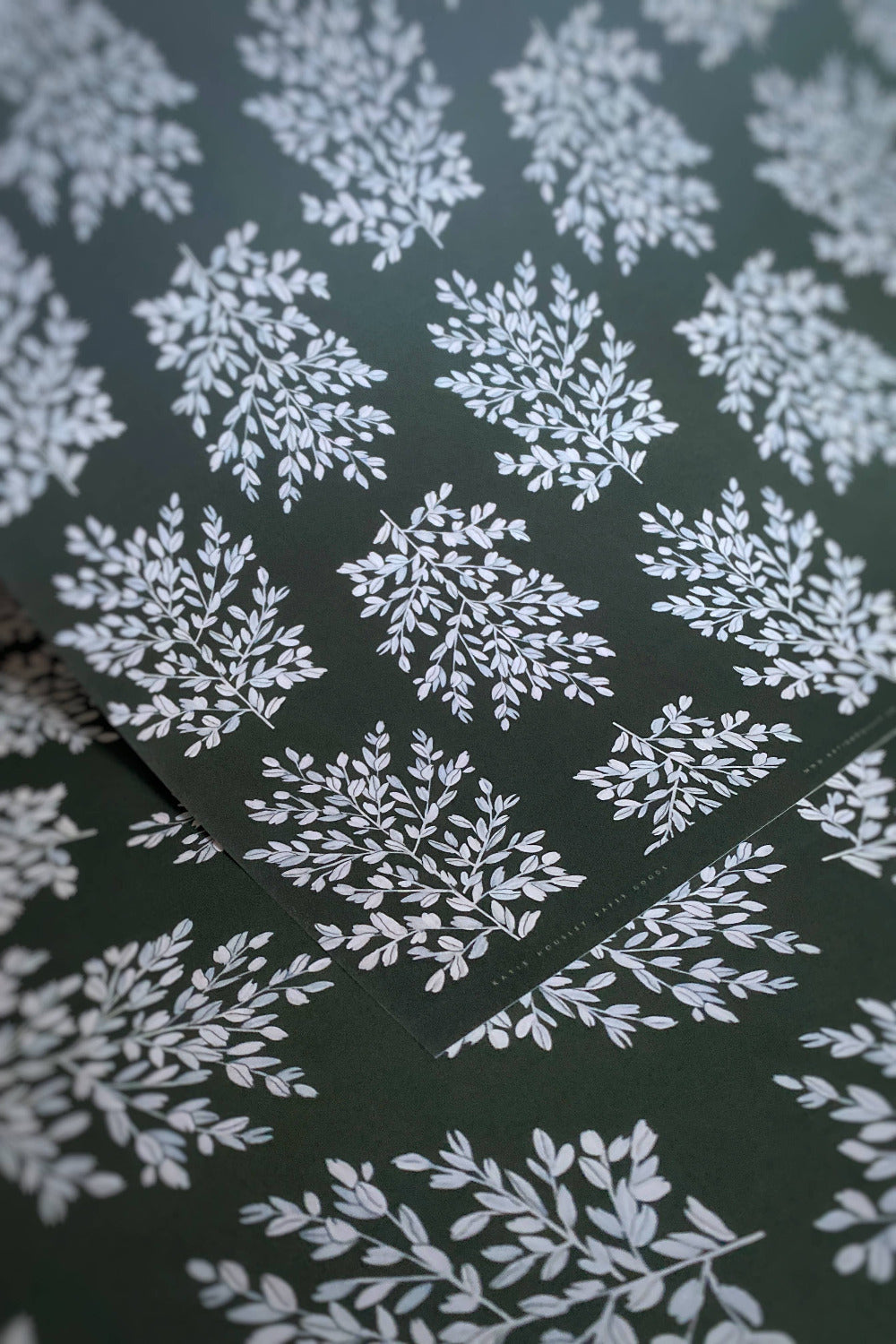 White leaf pattern on a dark green background