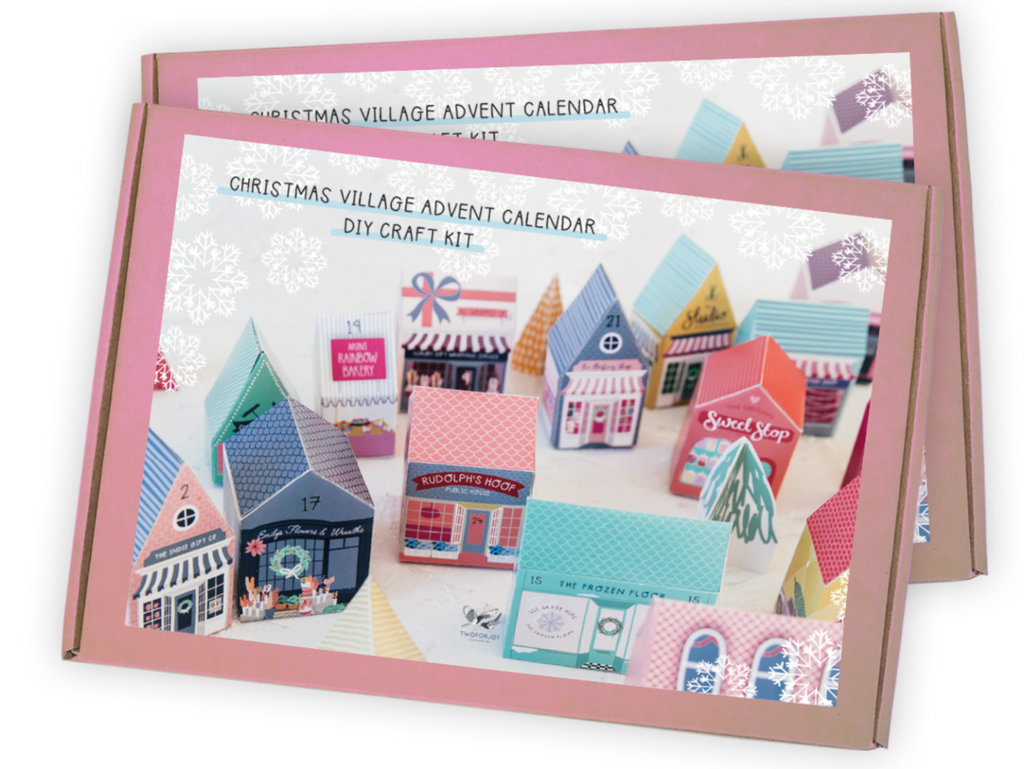 Christmas Village Advent Calendar DIY Craft Kit packaging with colorful houses on a white background