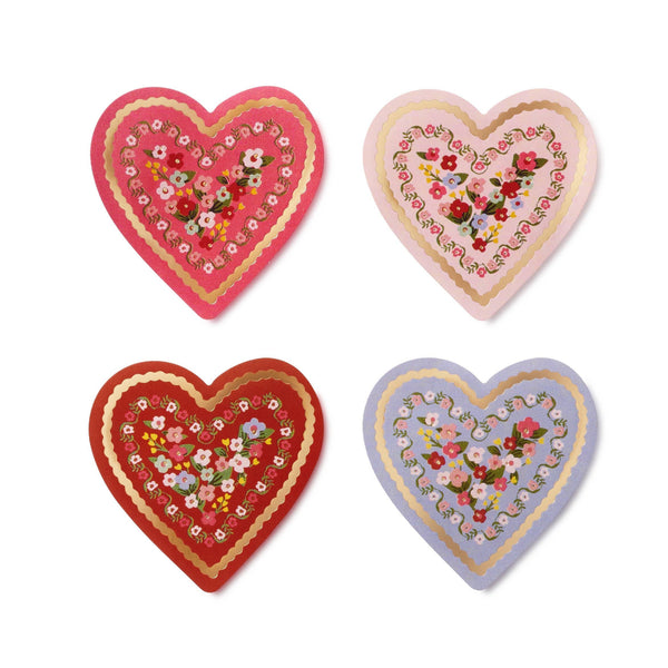 Four decorative heart-shaped items with floral patterns on a white background