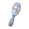 Hairbrush with dog illustrations on a blue floral patterned handle