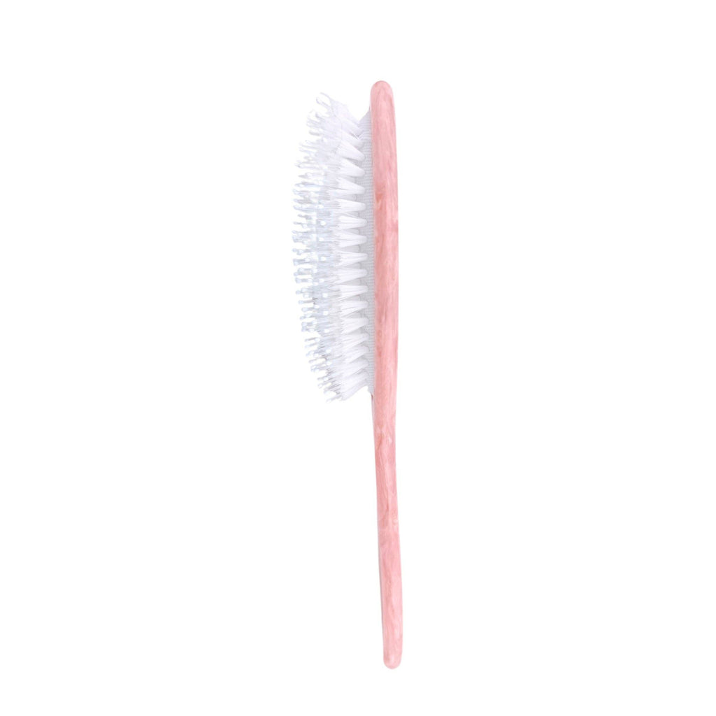 Pink toothbrush with white bristles on a white background