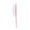 Pink toothbrush with white bristles on a white background