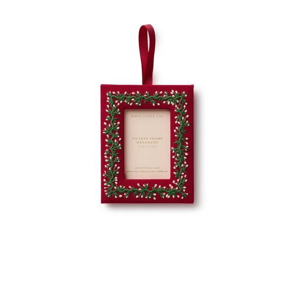 Red rectangular photo frame with greenery design on a white background