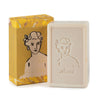 Bar of soap with embossed design and packaging featuring a woman's portrait on a white background