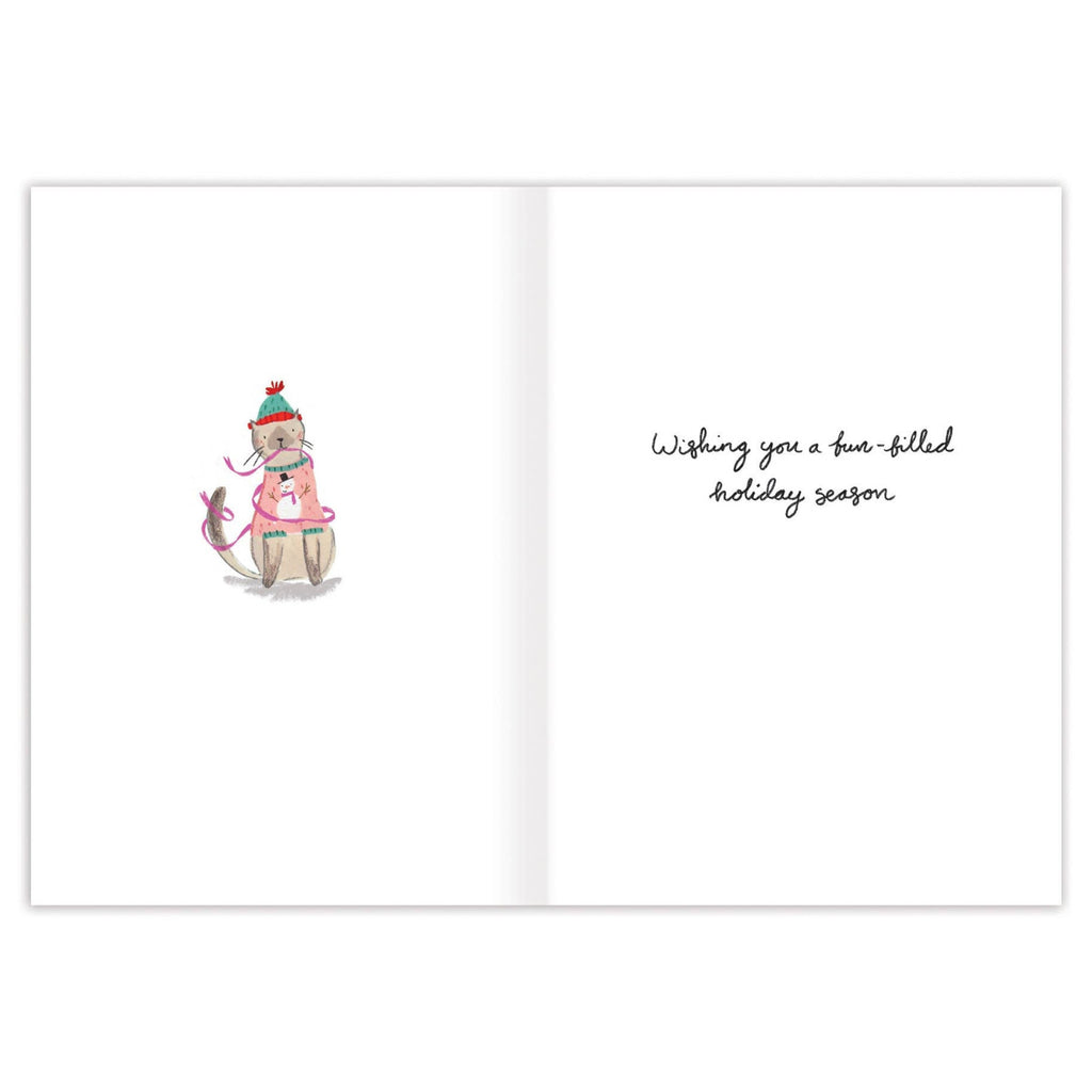 Greeting card with a cartoon dog wearing a Santa hat and scarf, and text 'Wishing you a fun-filled holiday season' on a white background.