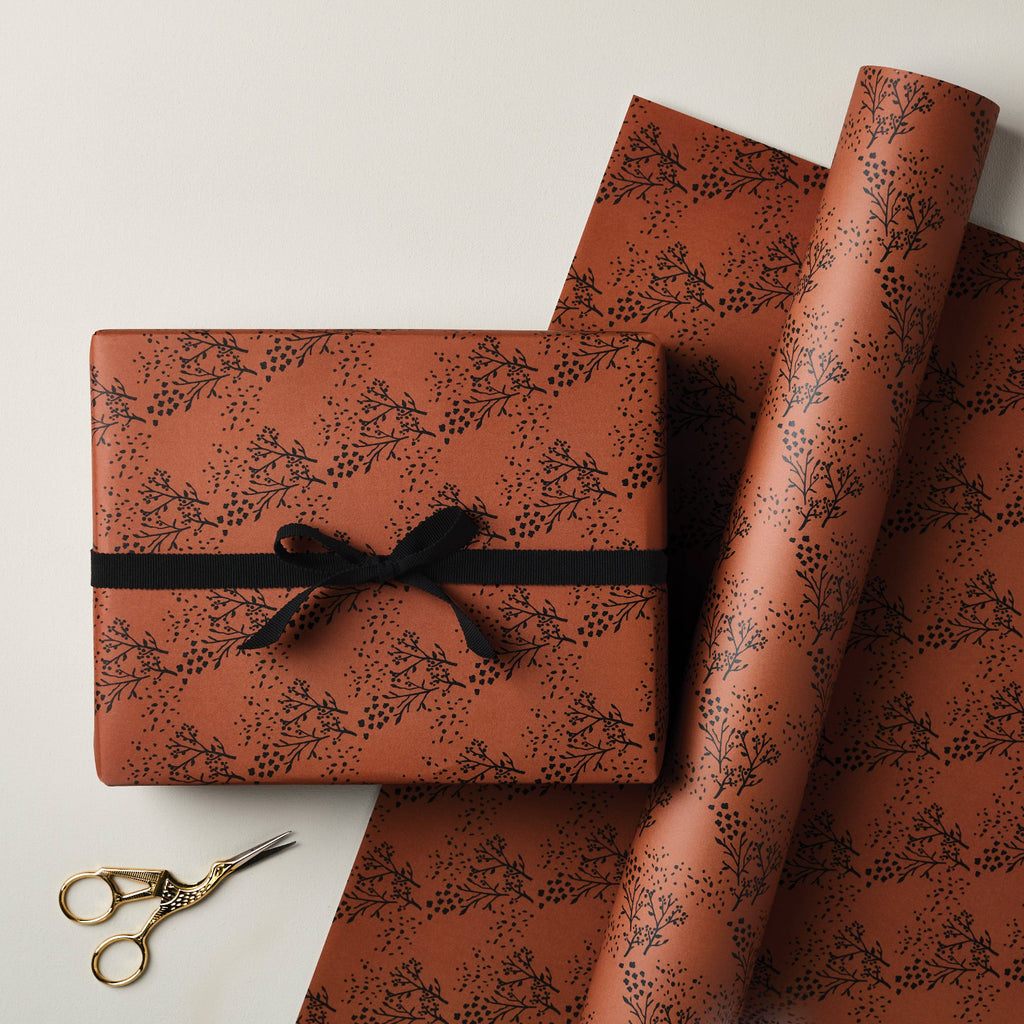 Gift box and wrapping paper with floral pattern on a light background
