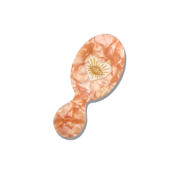 Marbled pink and orange hairbrush on a white background