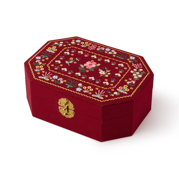 Decorative red box with floral embroidery on a white background