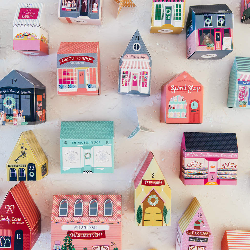 Collection of colorful house-shaped boxes on a light background