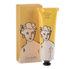 Divine hand cream with packaging featuring illustrations of a woman's face.