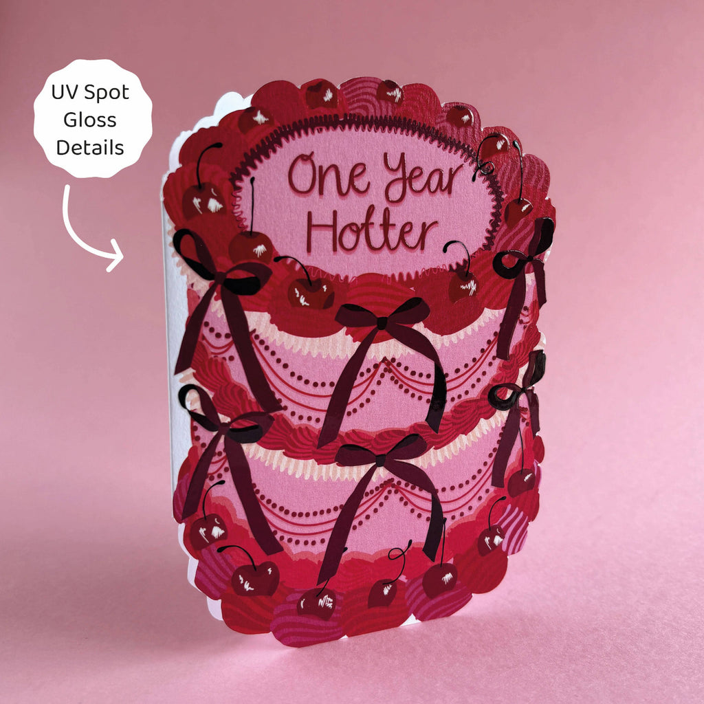 Card with lace design and 'One Year Hotter' text on a pink background