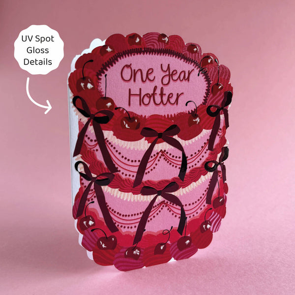 Card with lace design and 'One Year Hotter' text on a pink background