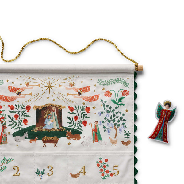 Decorative Advent calendar with nativity scene and angel ornament on a white background