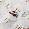 Embroidered advent calendar with numbers and festive designs on a white background