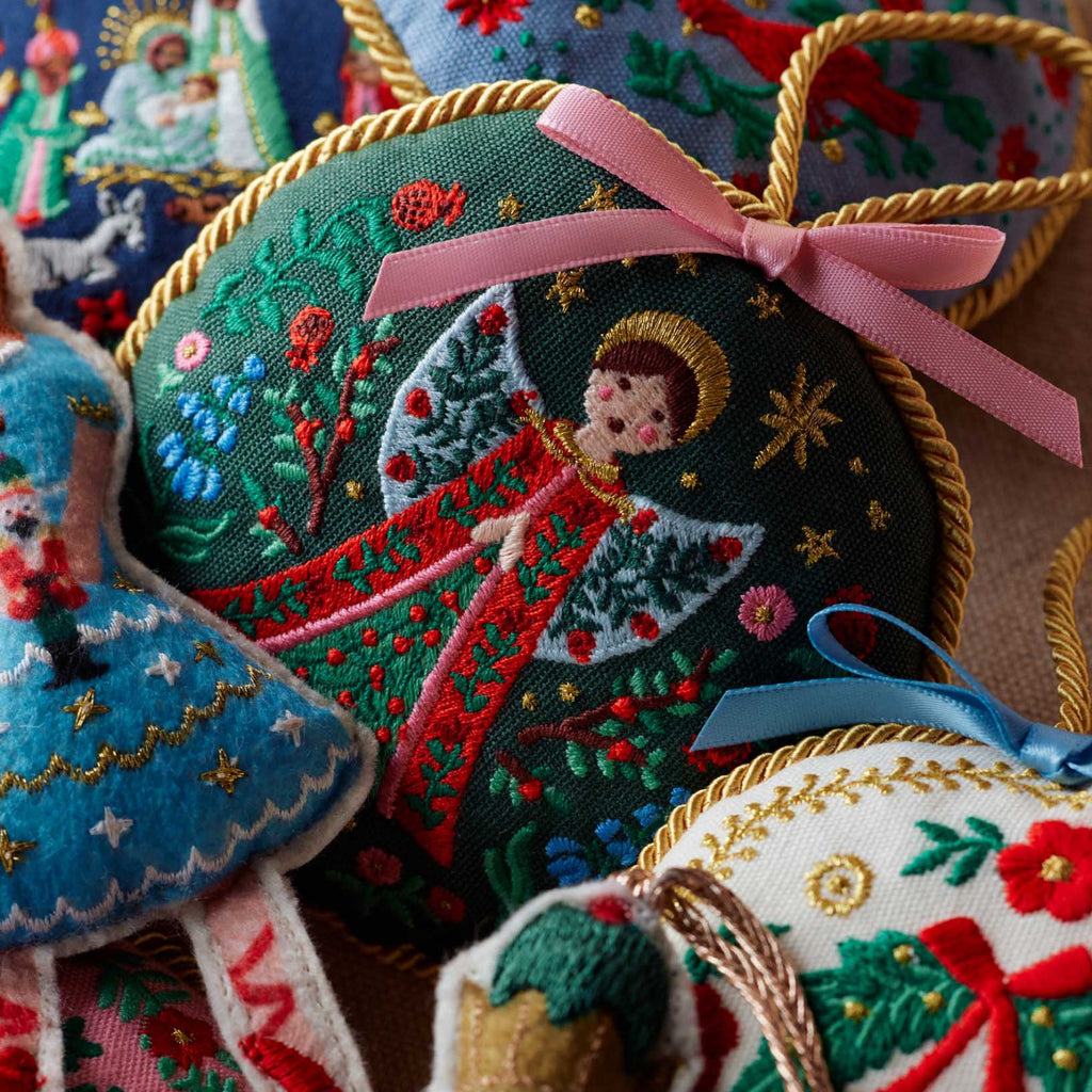 Embroidered Christmas ornaments with colorful designs and ribbons.