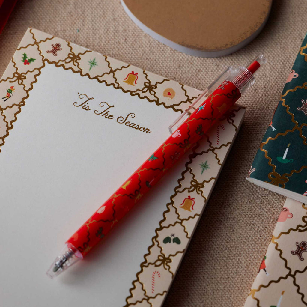 Red pen with Christmas design on a decorated card