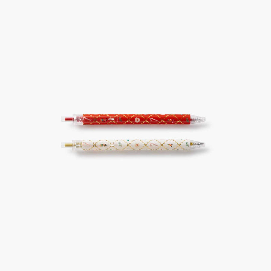 Two pens, one red and one white with gold accents, on a white background