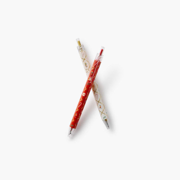 Two pens with decorative designs on a white background