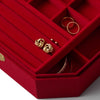 Red jewelry box with gold earrings and rings on a white background
