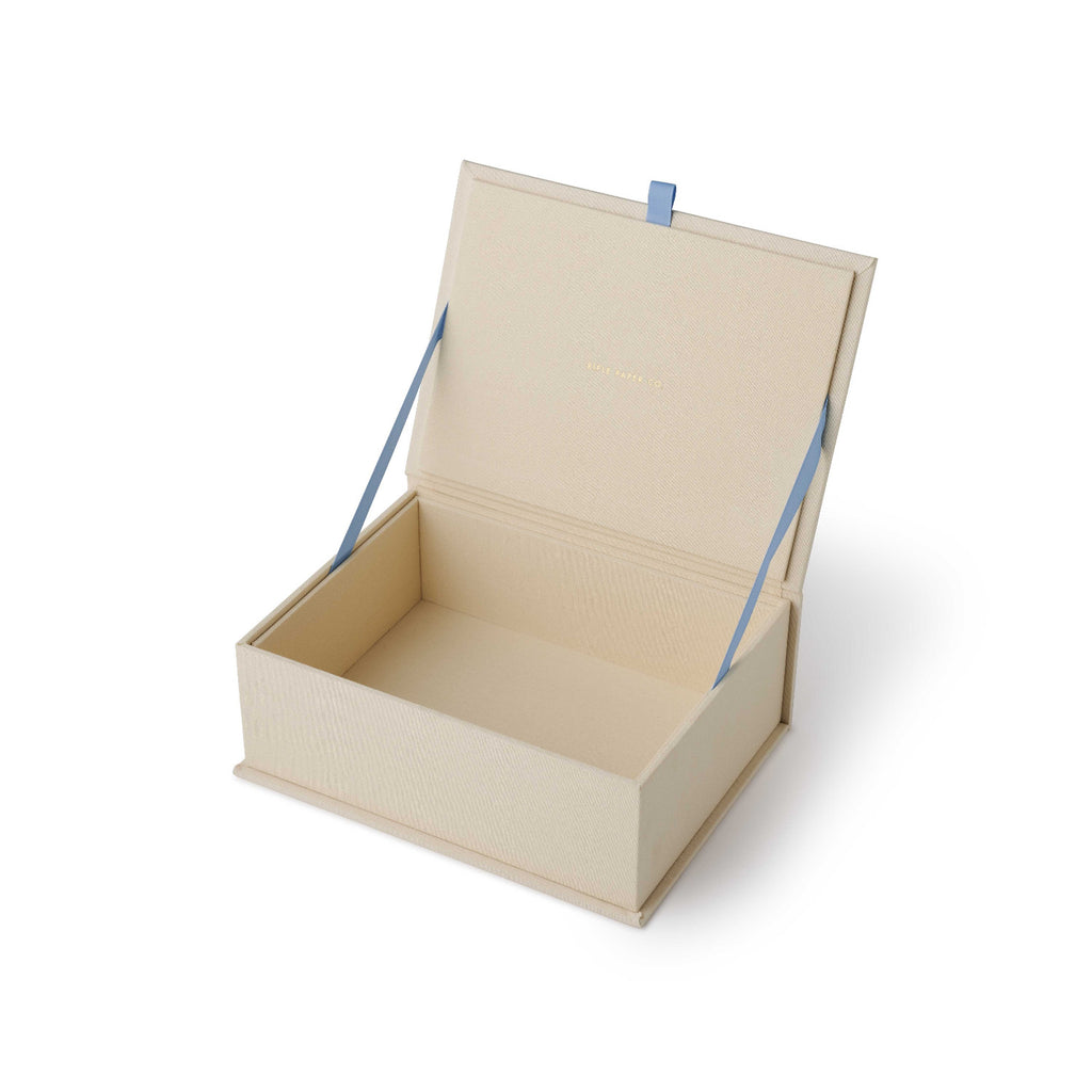 Beige cardboard box with a blue ribbon on a white background