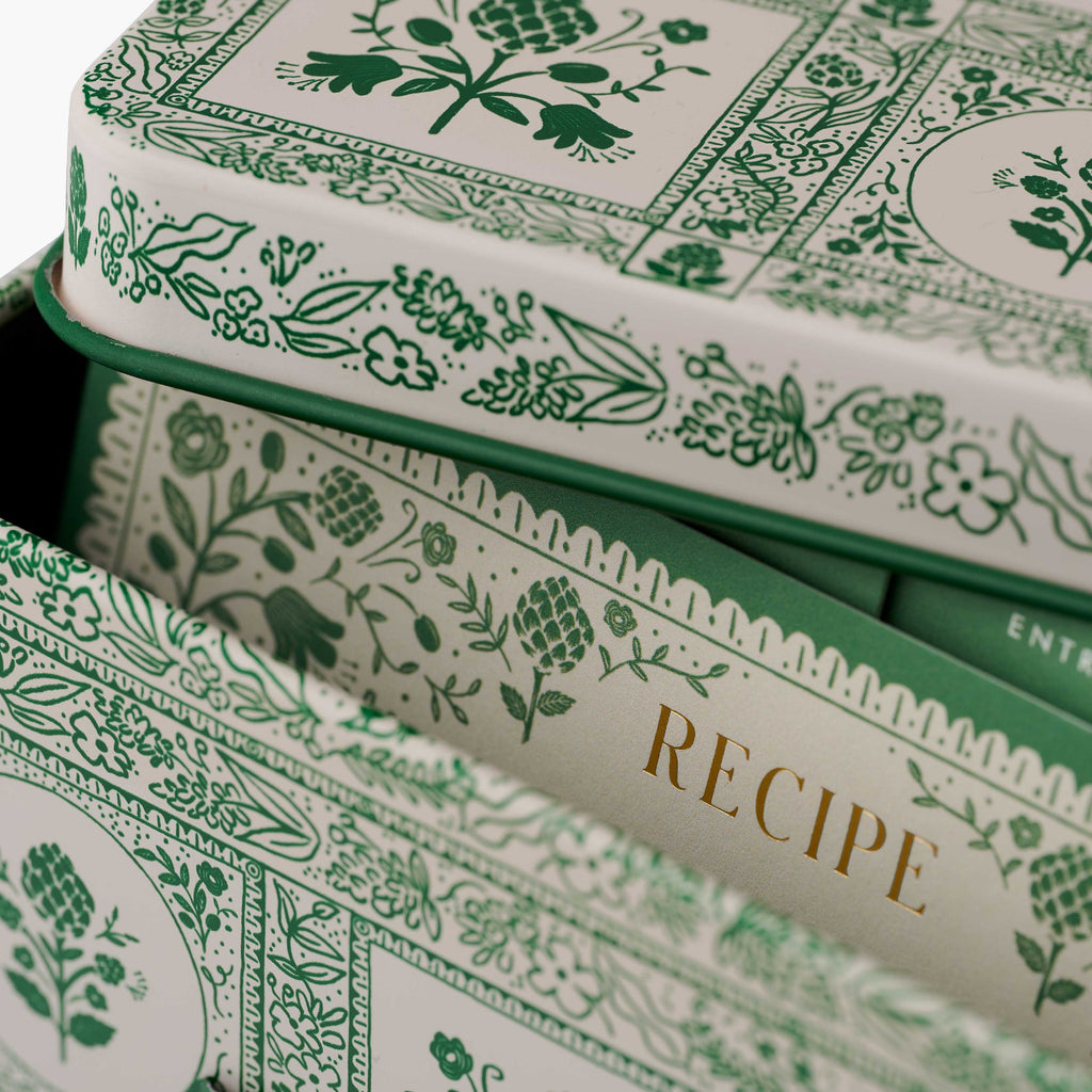Stack of recipe cards with green floral patterns on a white background