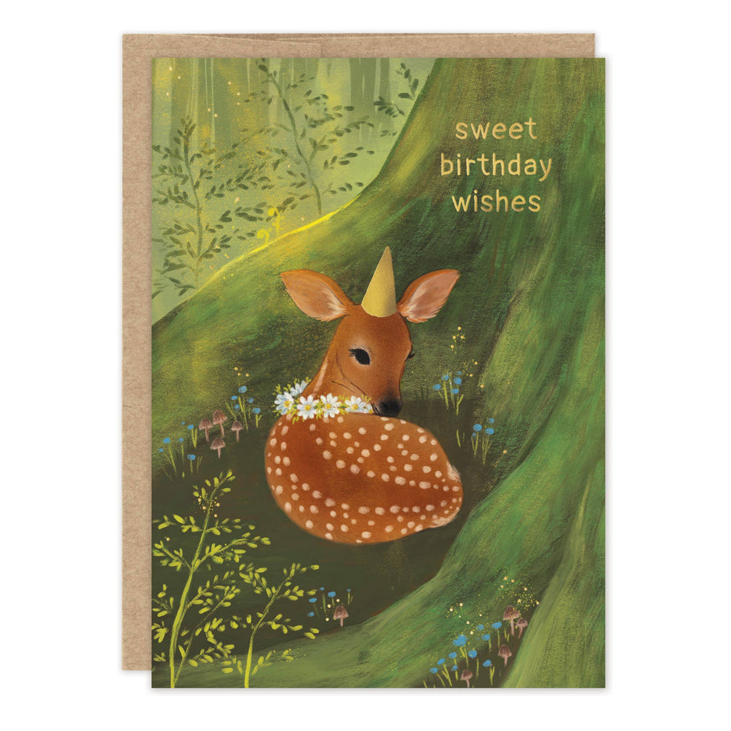 A greeting card with a kraft envelope, featuring an illustration of a fawn in a green forest with the text 'sweet birthday wishes'.