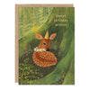 A greeting card with a kraft envelope, featuring an illustration of a fawn in a green forest with the text 'sweet birthday wishes'.