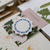 Floral-patterned sticky notes on a desk with stationery items.