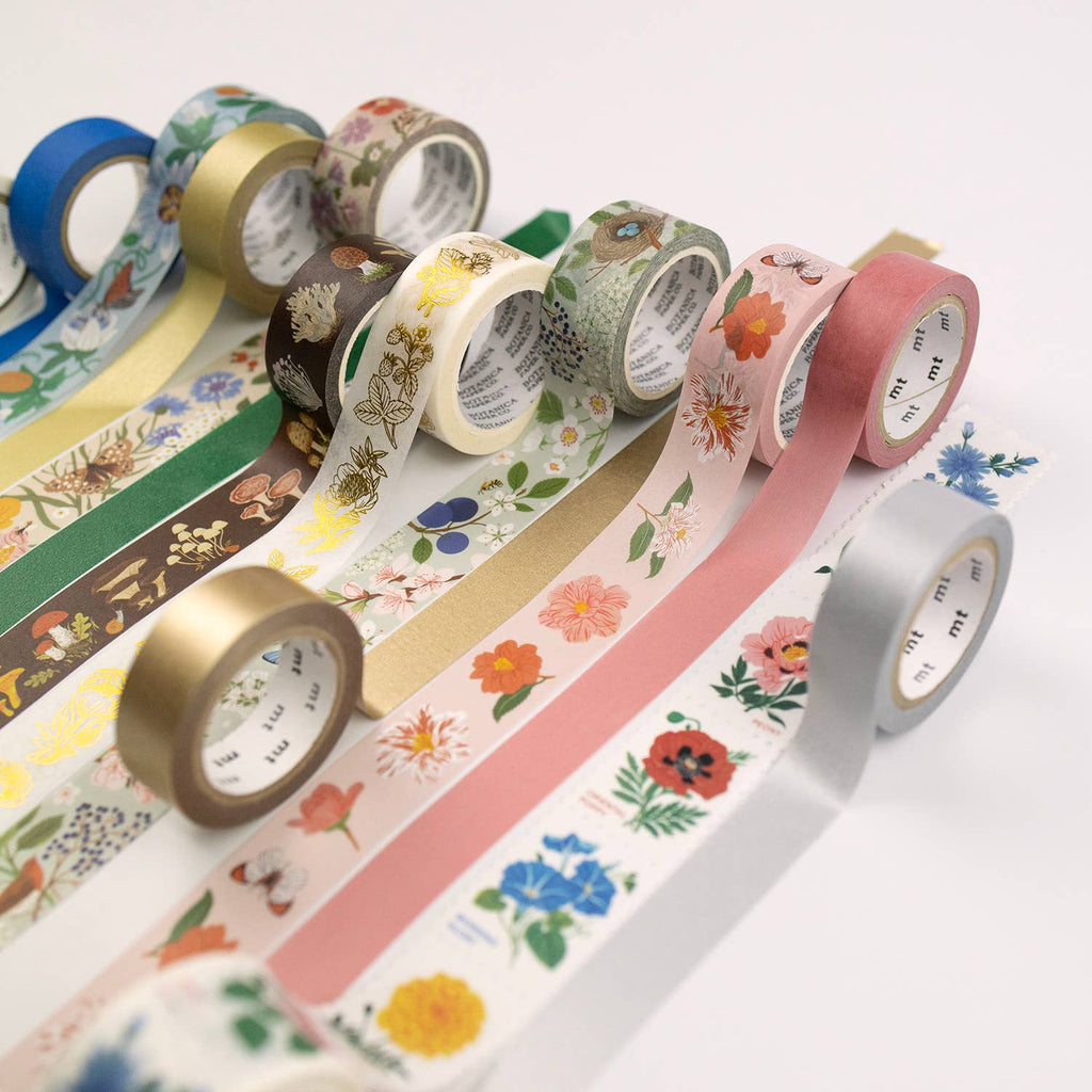 Assorted rolls of decorative tape with floral and patterned designs on a white background
